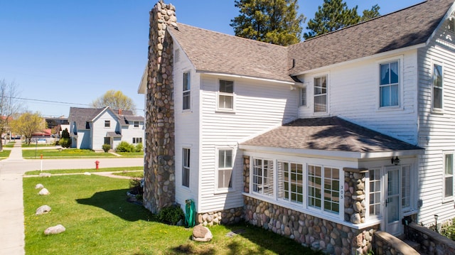 rear view of house featuring a yard