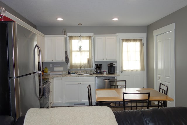 kitchen featuring white cabinetry, a wealth of natural light, and stainless steel appliances