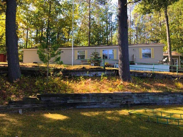 rear view of house featuring a lawn