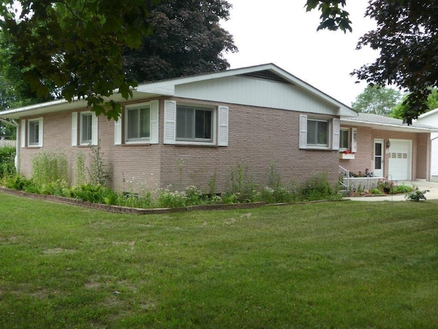 view of side of home with a garage and a lawn