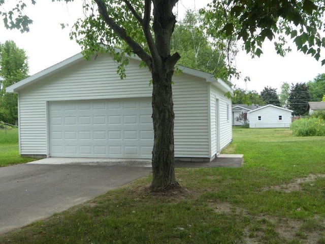 view of side of property with a lawn and a garage