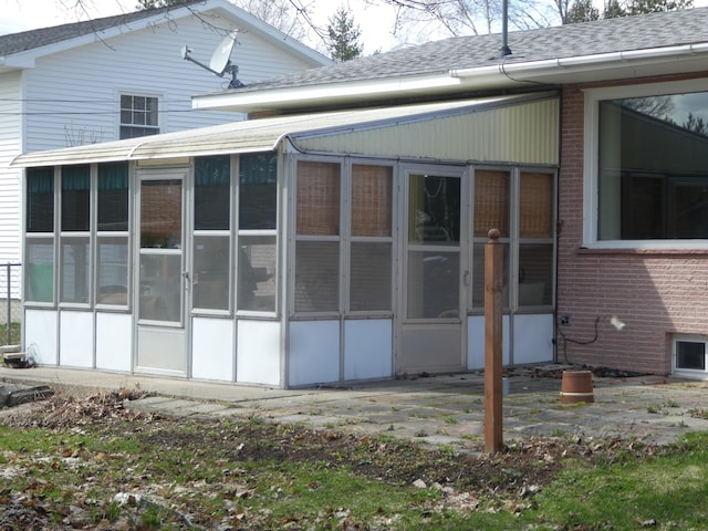 back of property with a sunroom