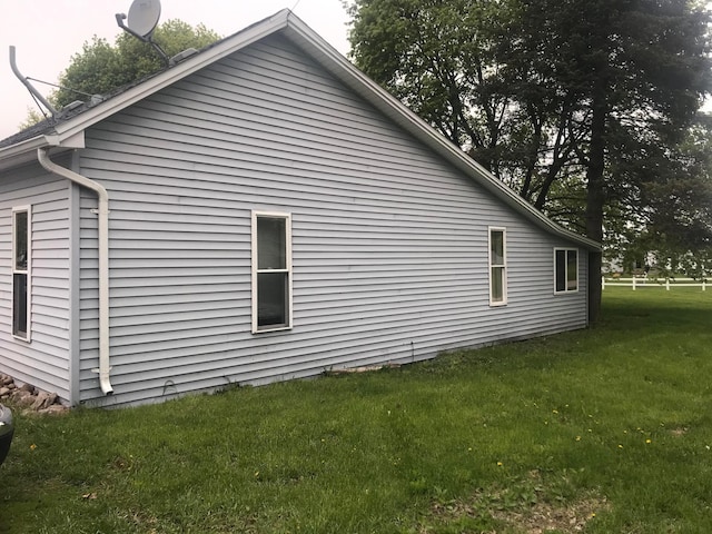 view of side of property with a yard