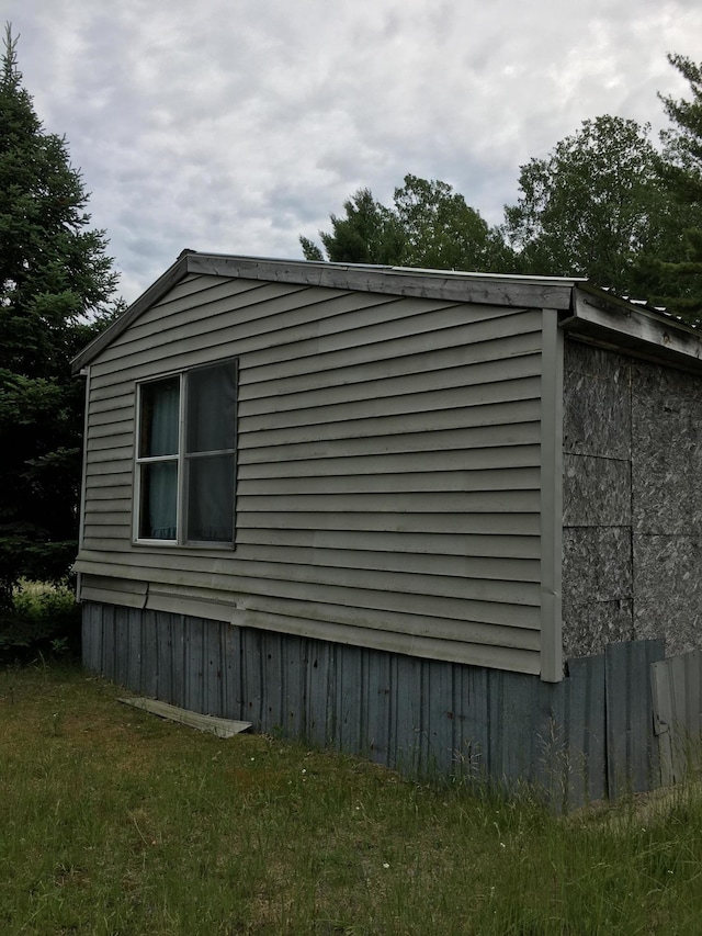 view of home's exterior with a lawn