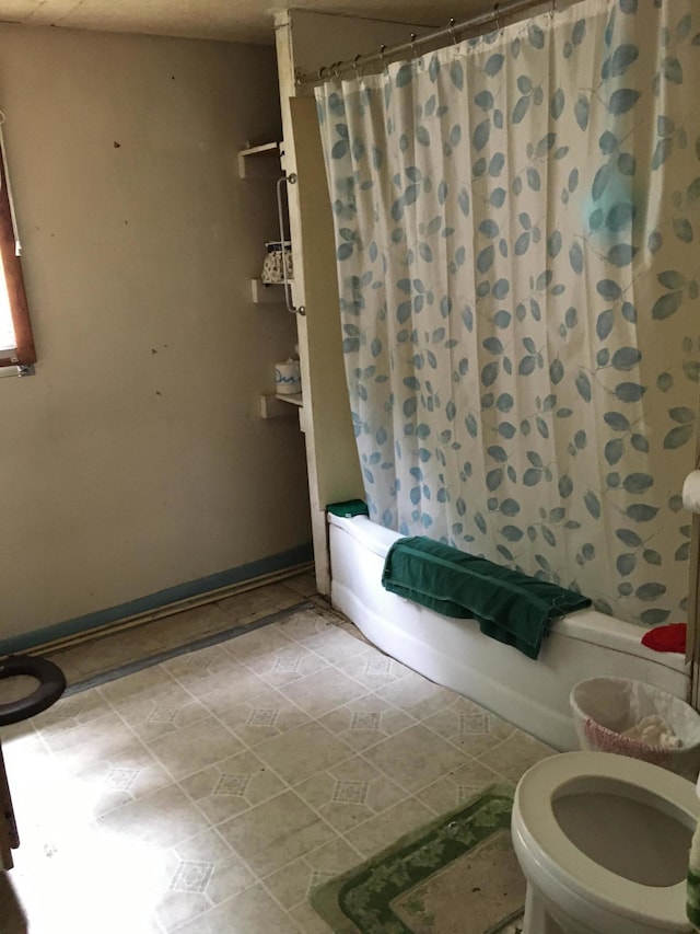 bathroom featuring toilet and tile flooring