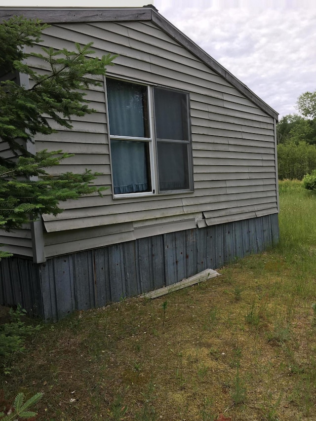 view of property exterior featuring a lawn