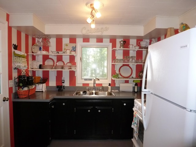 kitchen with white appliances, sink, and stainless steel counters