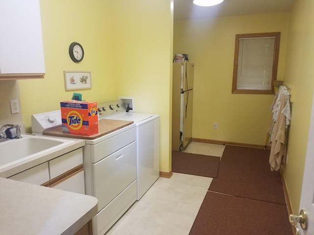 laundry room with light tile floors, sink, washing machine and dryer, cabinets, and hookup for a washing machine