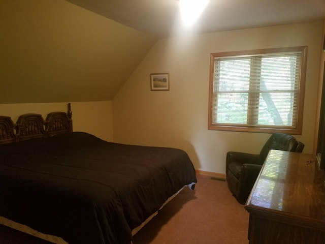 carpeted bedroom featuring vaulted ceiling