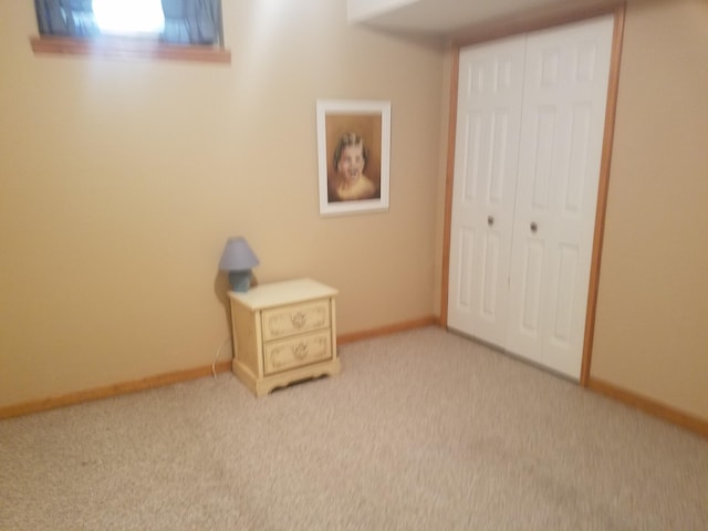 unfurnished bedroom featuring a closet and light carpet