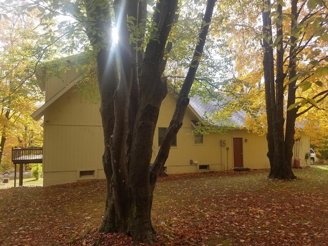 view of property exterior featuring a wooden deck