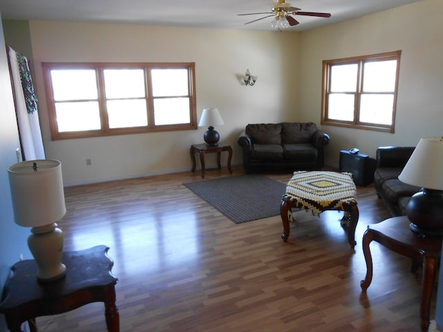 living room with dark hardwood / wood-style floors and ceiling fan