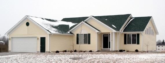 modern inspired farmhouse with a garage