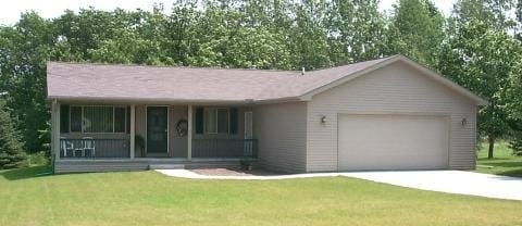 single story home featuring a porch, a front lawn, and a garage