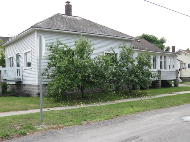 view of side of home featuring a yard