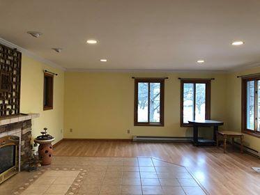 unfurnished living room featuring tile floors and crown molding