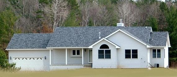 rear view of property with a garage