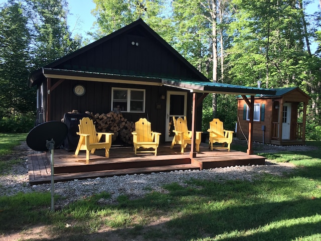 back of house with a wooden deck