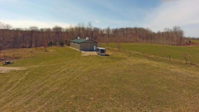 view of yard with an outdoor structure and a rural view