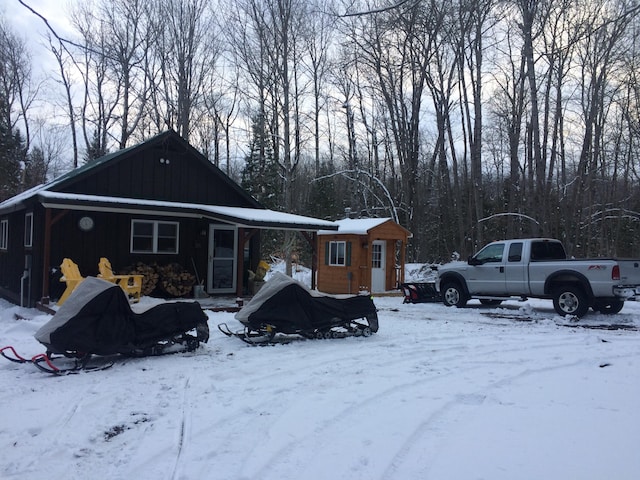 view of snow covered back of property