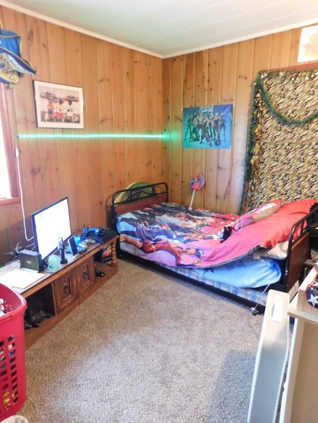 carpeted bedroom featuring wooden walls