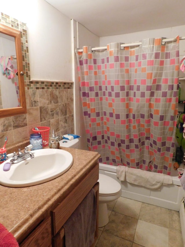 full bathroom featuring toilet, oversized vanity, shower / bath combination with curtain, backsplash, and tile floors