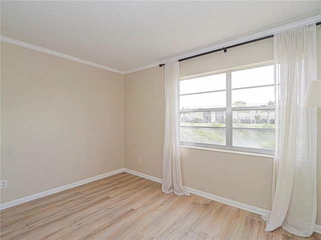 spare room with a textured ceiling, light hardwood / wood-style floors, ornamental molding, and a water view