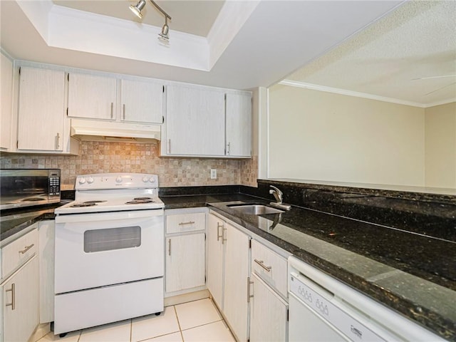 kitchen featuring sink, dark stone counters, white appliances, decorative backsplash, and light tile patterned floors