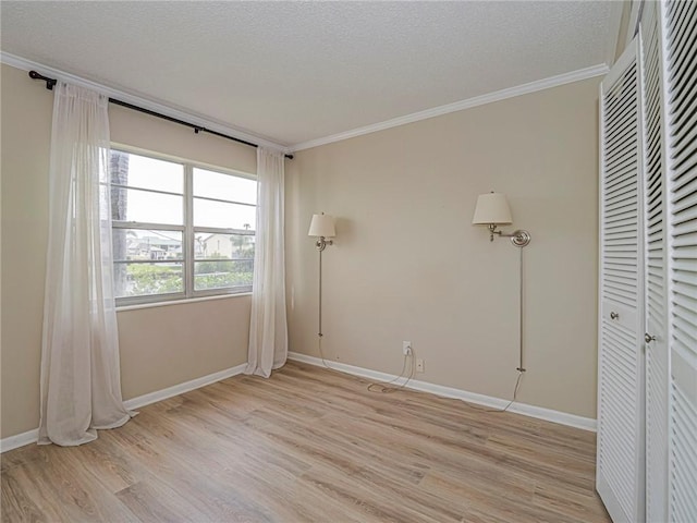 unfurnished bedroom with crown molding, light hardwood / wood-style flooring, and a textured ceiling