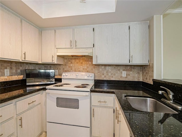 kitchen featuring decorative backsplash, white range with electric stovetop, dark stone counters, and sink