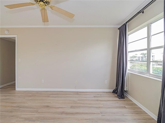 spare room featuring light wood-type flooring, ceiling fan, and crown molding