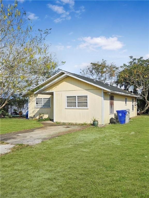 view of side of property with a lawn