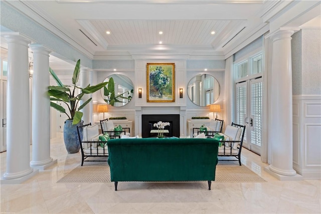 sitting room featuring a decorative wall, marble finish floor, decorative columns, ornamental molding, and a fireplace