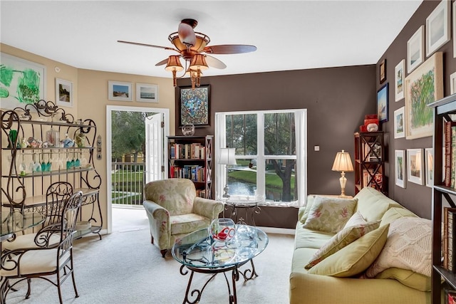 carpeted living room featuring plenty of natural light and ceiling fan