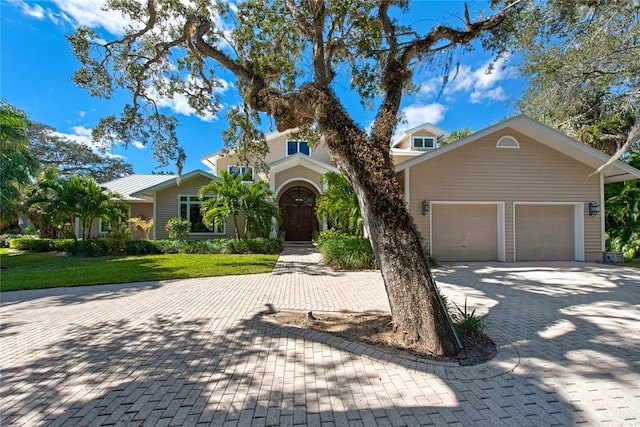 view of front facade with a front yard and a garage