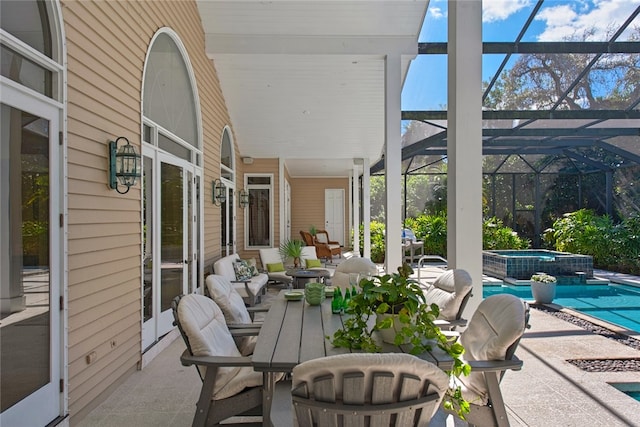 view of patio with a swimming pool with hot tub and glass enclosure