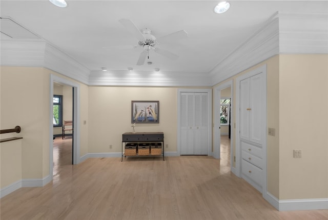 hall featuring crown molding and light hardwood / wood-style floors