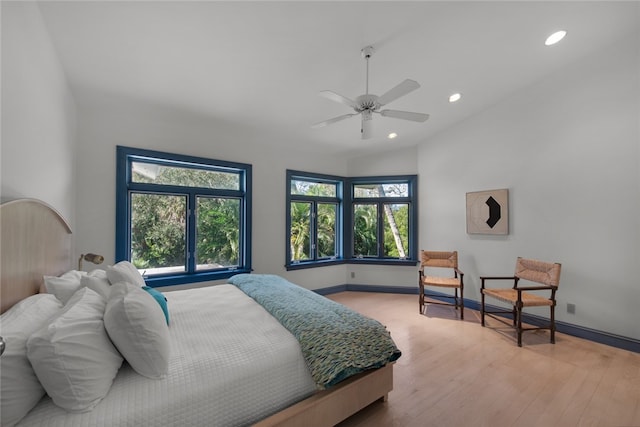 bedroom featuring ceiling fan, lofted ceiling, and wood-type flooring