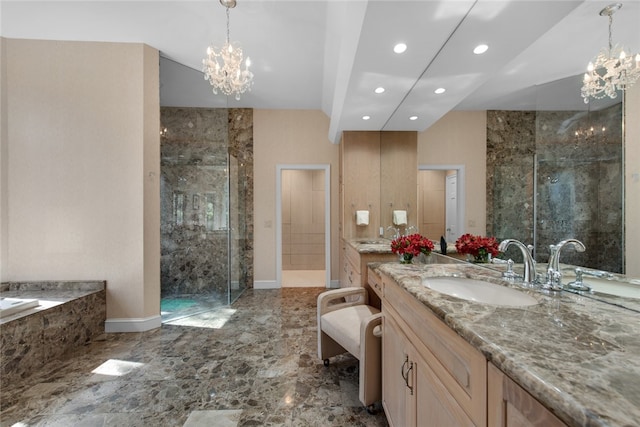 bathroom with vanity, a chandelier, and a tile shower