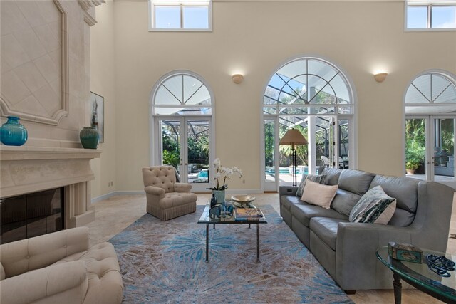 carpeted living room featuring french doors and a towering ceiling