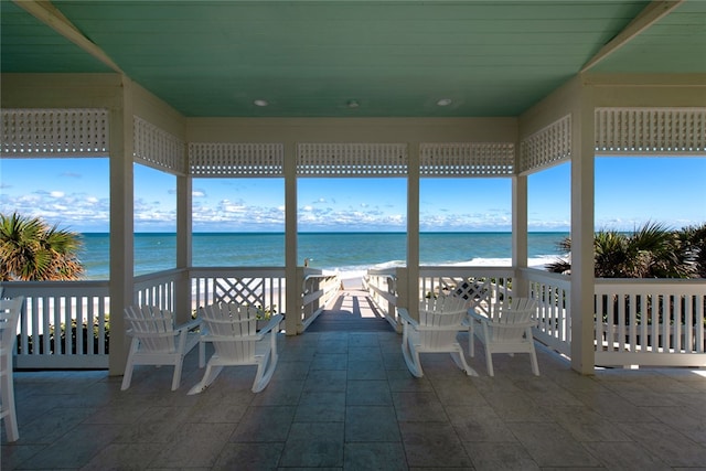 view of patio with a view of the beach and a water view