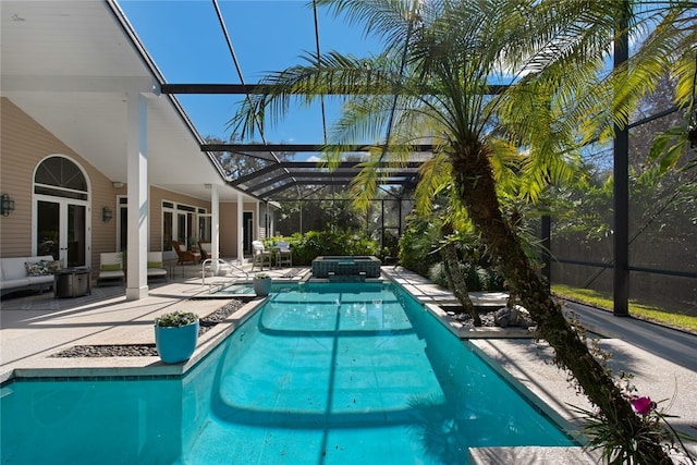 view of pool with an in ground hot tub, a lanai, and a patio