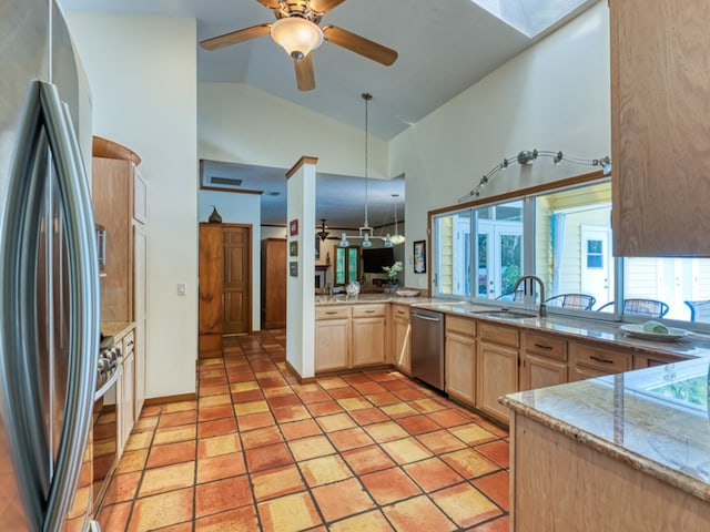 kitchen featuring kitchen peninsula, stainless steel appliances, sink, light brown cabinets, and high vaulted ceiling