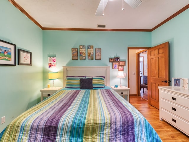 bedroom with light hardwood / wood-style floors, ceiling fan, and ornamental molding