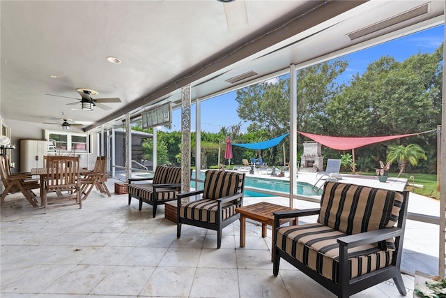 sunroom / solarium featuring ceiling fan and a healthy amount of sunlight