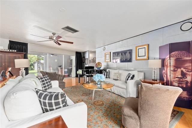 living room featuring light hardwood / wood-style floors and ceiling fan