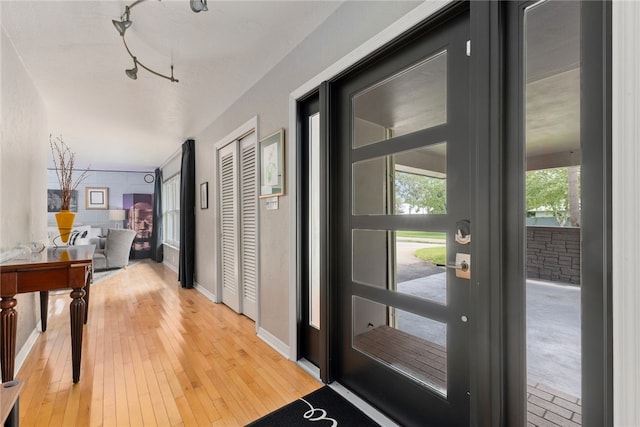 entryway featuring hardwood / wood-style floors and rail lighting