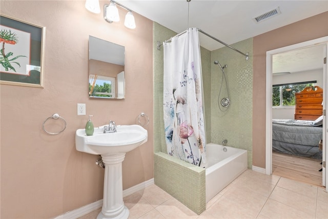 bathroom with tile patterned floors, sink, and shower / tub combo