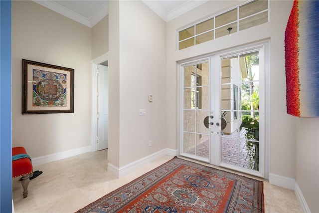 entrance foyer with crown molding and french doors