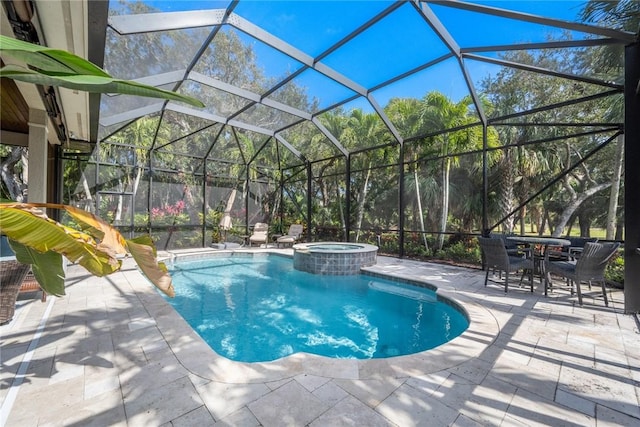 view of swimming pool with a lanai, a patio area, and an in ground hot tub